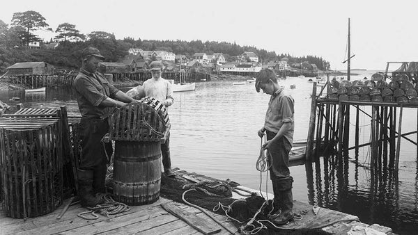 Black and white image of young fishermen on the Maine coast.