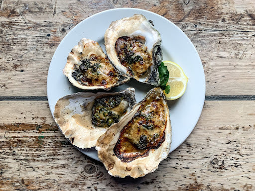 Grilled oysters with salsa verde butter. 