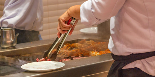 chef grilling lobsters in a commissary kitchen