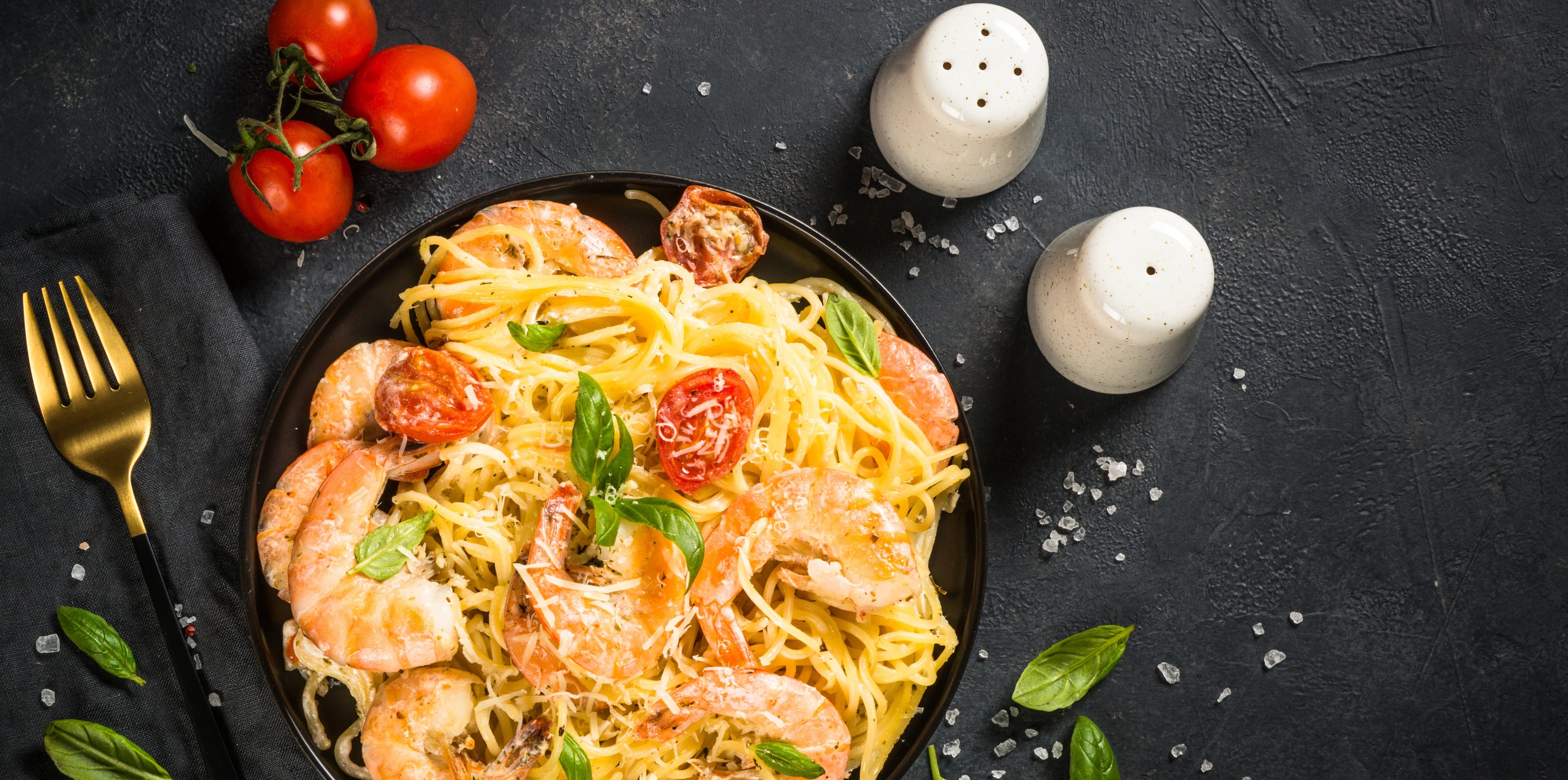 seafood pasta on a black bowl posted by get maine lobster