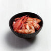 Bowl of flash-frozen Maine lobster claw and knuckle meat, showcasing rich red color and tender texture-perfect for cooking or serving chilled.