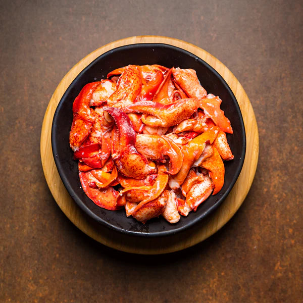Bowl of fresh, flash-frozen wild-caught Maine lobster meat, ready for roll assembly.
